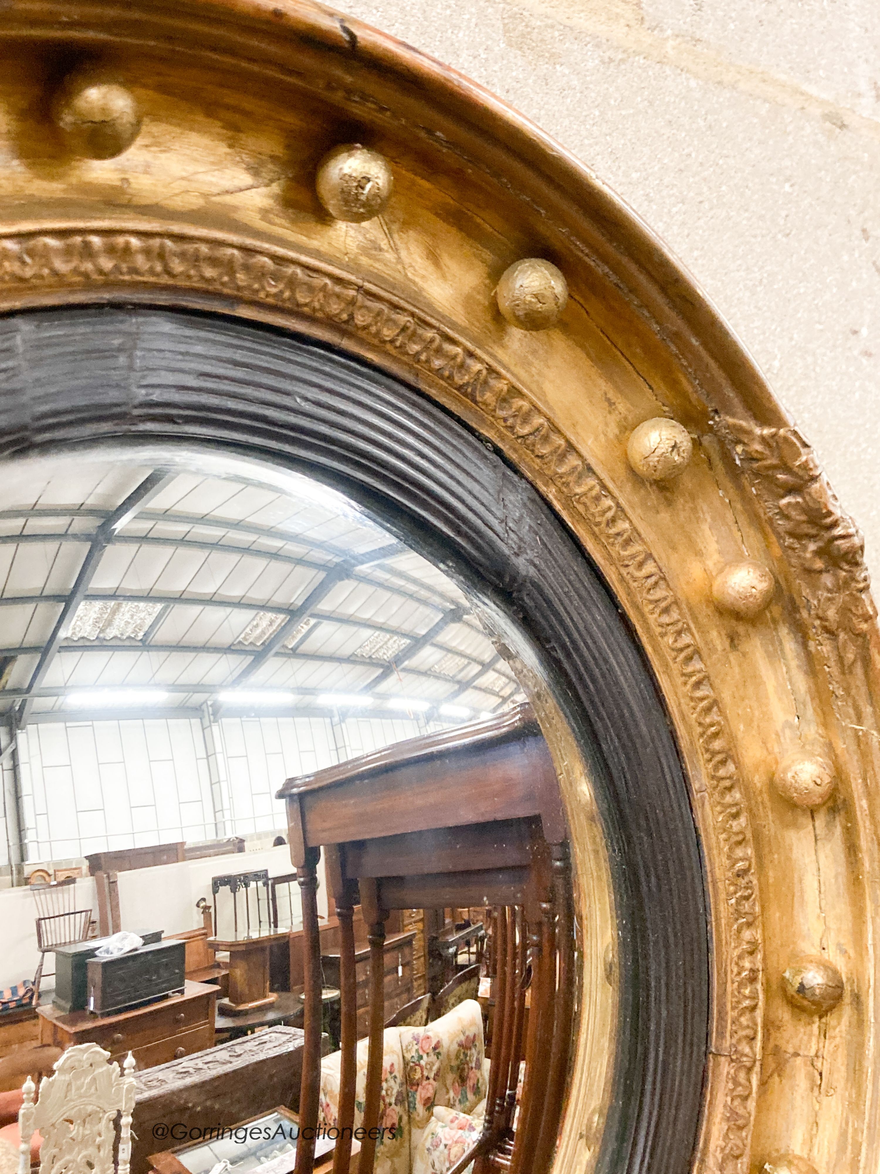 A Victorian giltwood and gesso convex wall mirror, diameter 47cm